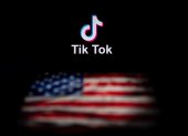 (FILES) In this file photo illustration taken on September 14, 2020, shows the logo of the social network application TikTok and a US flag on the screens of two laptops in Beijing. - US officials on September 18, 2020, ordered a ban on downloads of the popular Chinese-owned mobile applications WeChat and TikTok from September 20, saying they threaten national security. The move comes amid rising US-China tensions over technology and a Trump administration effort to engineer a sale of the video app TikTok to American investors. (Photo by NICOLAS ASFOURI / AFP)