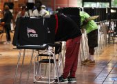 MIAMI, FLORIDA - OCTOBER 21: Voters fill out their ballots as they vote at the Stephen P. Clark Government Center polling station on October 21, 2020 in Miami, Florida. The state of Florida saw a record-breaking first day of early voting with over 3.1 million votes cast. The early voting ends on Nov. 1. Voters are casting their ballots for presidential candidates President Donald Trump and Democratic presidential nominee Joe Biden.   Joe Raedle/Getty Images/AFP