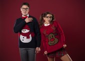 Crazy nerd couple in funny sweaters goofing around