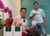 Josué y Pepe posan y muestran su emprendimiento de café para filtrar.