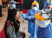 Personal médico realiza los chequeos y pruebas de PCR, a los pasajeros que llegan al aeropuerto de Quito (Ecuador).