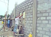 Trabajo.- Albañiles en una construcción de casas.