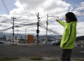Las Casas. Erick Zumba señala la cantidad de cables que están desordenados en un poste en este sector.