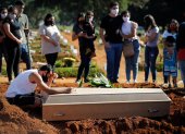 Fotografía de archivo en al que se registró a una familia durante el entierro de un familiar víctima de la covid-19, en el cementerio Vila Formosa, en Sao Paulo (Brasil).