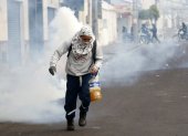 Protestas. Manifestantes portando elementos explosivos durante la protesta de este martes.