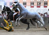 Siena (Italy), 02/07/2022.- Italian jockey Stefano Piras, who races for the "Bruco" district, falls during a false start of his horse "Uragano Rosso" during the historical Italian horse race Palio di Siena, in Siena, Italy, 02 July 2022. After two years of stop for the pandemic, it was won by the "Dragon" district. The traditional horse races between the Siena city districts will be held 02 July as the "Palio di Provenzano" on the holiday of the Madonna of Provenzano and on 16 August as the "Palio dell"Assunta" on the holiday of the Virgin Mary. (Italia) EFE/EPA/CLAUDIO GIOVANNINI