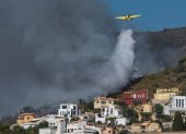Una avioneta descarga agua sobre el fuego originado en Vall d"Ebo, provincia española de Alicante.