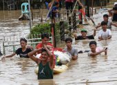 Ciudadanos caminan con el agua hasta la cintura debido a la inundación provocada por el tifón Noru en la localidad de San Miguel de Bulacan, en la isla de Luzón, Filipinas. EFE/EPA/ROLEX DELA PENA