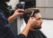 Male client getting haircut by hairdresser