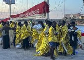 Migrantes rescatados en el Mediterráneo central llegan al puerto italiano de Lampedusa.