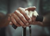 Hand of a old man holding a cane. Senior Man Holding Cane. Close-up Of old man Hands On Walking Stick.