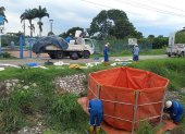 Trabajadores de diversas entidades públicas realizan tareas de limpieza en el canal tras el derrame.