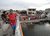 Ocio. Un grupo de jóvenes se baña en el Salado bajo el puente de la calle 17, en el suroeste guayaquileño.