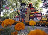 Fotografía del 19 de octubre de 2024 de un hombre disfrazado de catrín frente a una mega ofrenda de Día de Muertos, en la antigua Hacienda San Mateo del municipio de Atlixco (México).