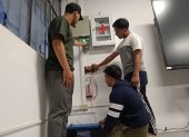 Estudiantes de la Universidad de Cuenca indican las instalaciones eléctricas que permiten transformar la energía de su aula a solar cuando hay cortes de luz.