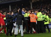 La policía tiene que intervenir para separar a jugadores de ambos equipos durante el partido de la Premier League que han jugado Everton FC y Liverpool FC.