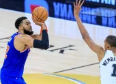 El pívot de los New York Knicks Karl-Anthony Towns tira al aro con la marca del alero de los San Antonio Spurs Victor Wembanyama