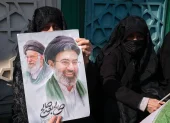 Un mujer porta una pancarta con la imagen del nuevo líder supremo de Irán, Mojtaba Jameneí, en la plaza Enghelab de Teherán.