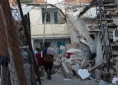 Personas buscan entre los escombros de las edificaciones destruidas por los terremotos.