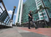 Una persoma camina al pie de los condominios que quedan en Puerto Santa Ana, en Guayaquil.