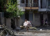 Los supervivientes de las inundaciones regresan a sus hogares tras una crecida repentina en la aldea de Devighat, distrito de Nuwakot, Nepal, el 27 de agosto de 2026.