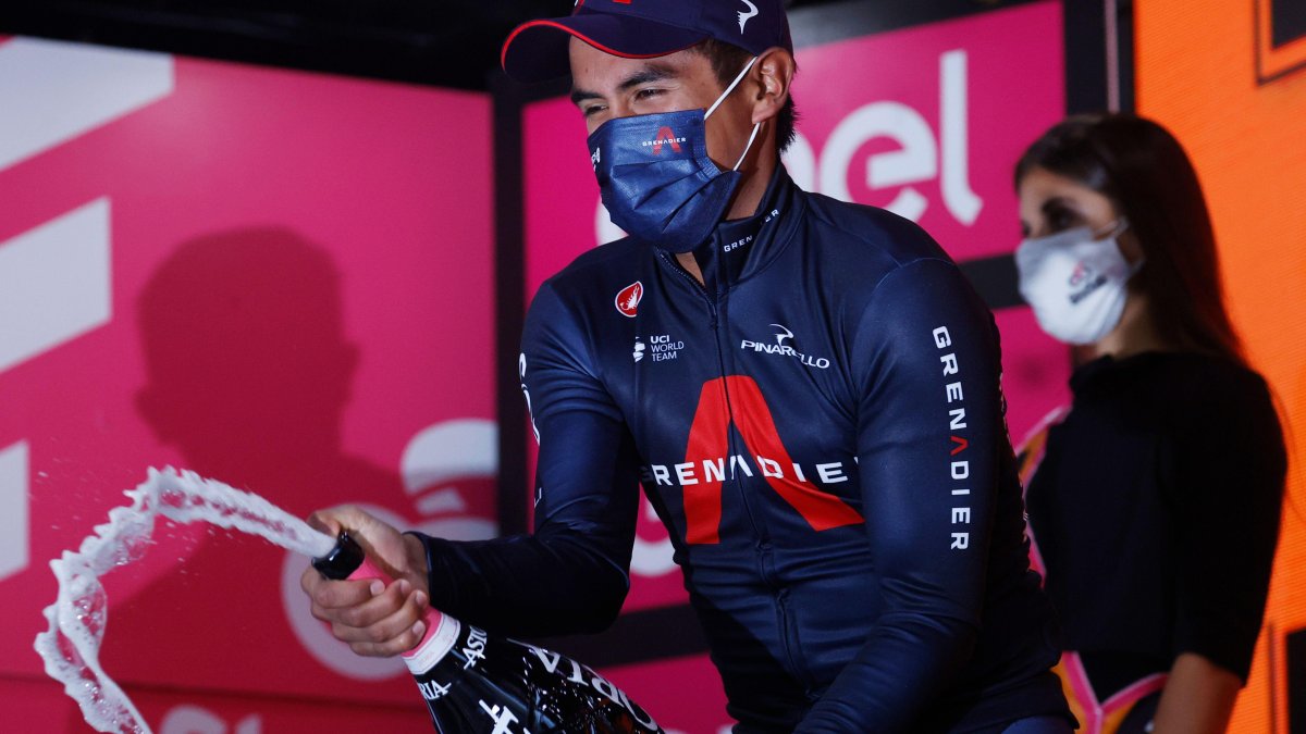 El ciclista ecuatoriano en la cúspide celebrando con el champán de los ganadores de etapa del Giro de Italia 2020.