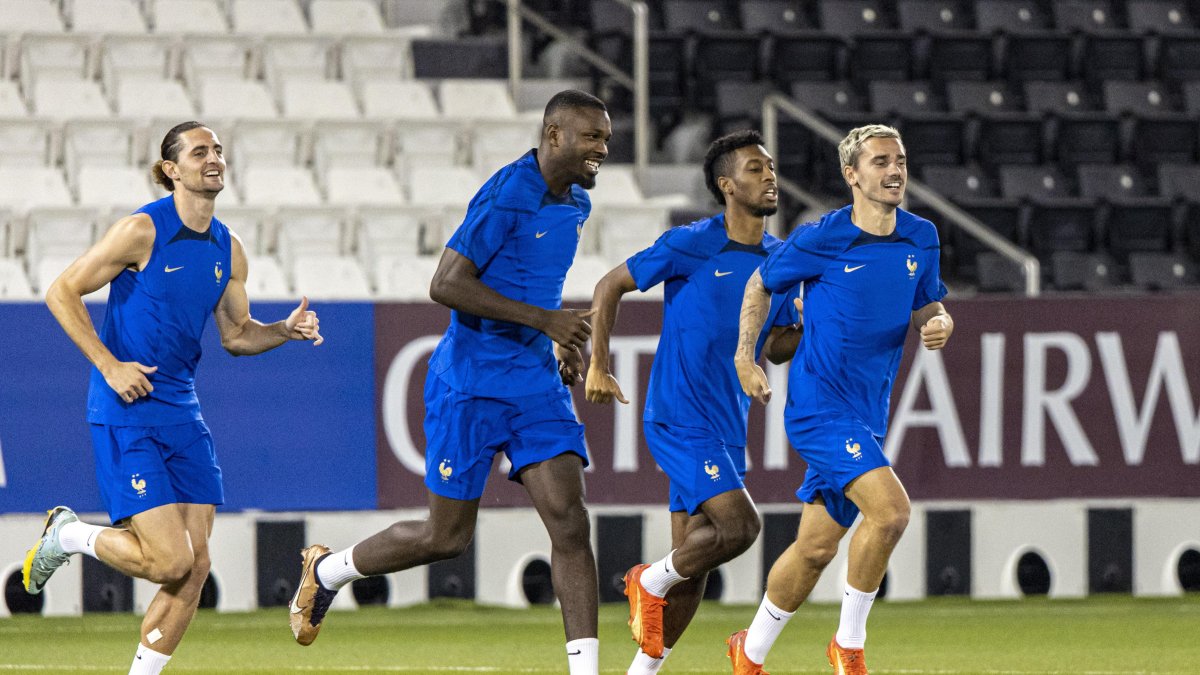 Adrien Rabiot (i), mediocentro francés, se entrena junto a sus compañeros de selección Marcus Thuram, Kingsley Coman y Antoine Griezmann (d) en el estadio Al Sadd SC de Doha.