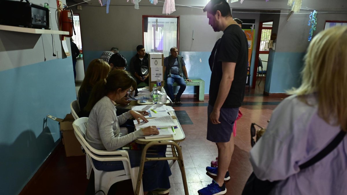 Personas asisten hoy, en un centro de votaciones en Buenos Aires (Argentina). Sergio Massa y Javier Milei son los dos candidatos del balotaje argentino y al final de la jornada uno de ellos será elegido como el futuro presidente del país.