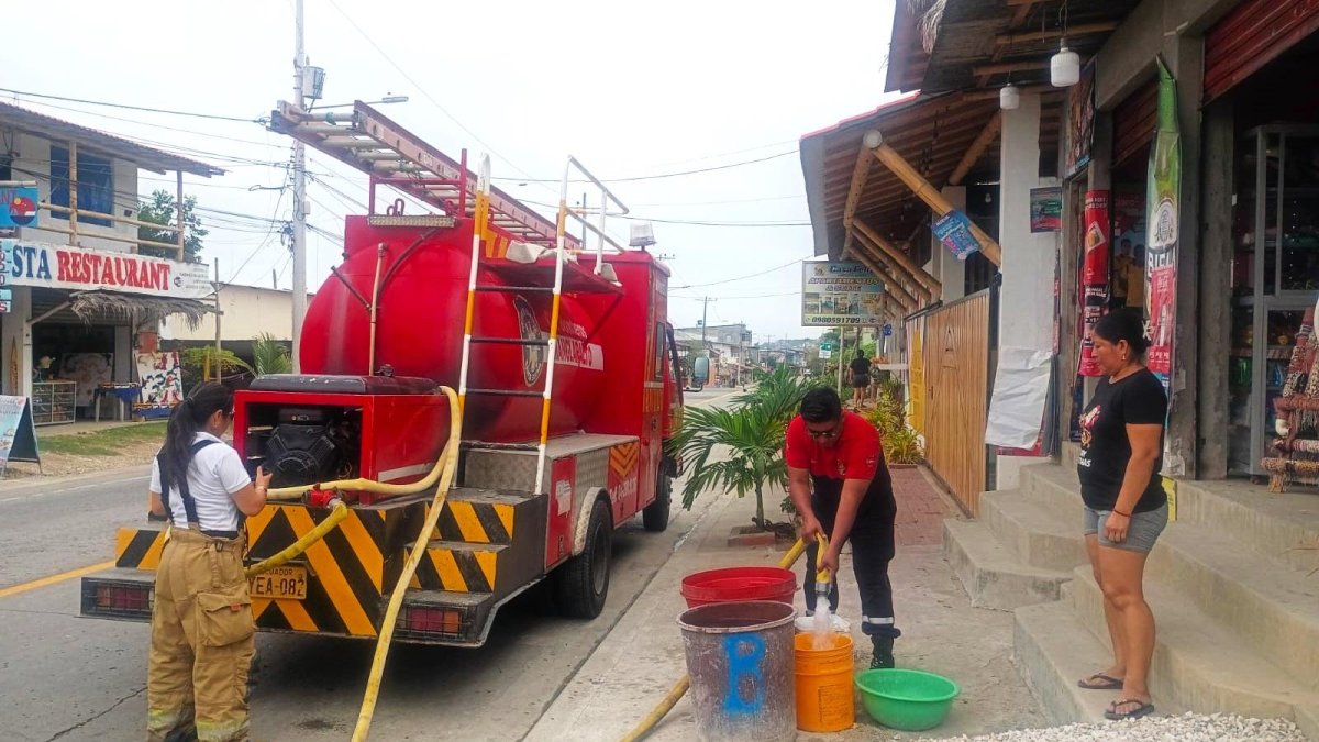Personal del cuerpo de bomberos de Manglaralto colabora en el abastecimiento del líquido vital a los sectores donde el agua no llega