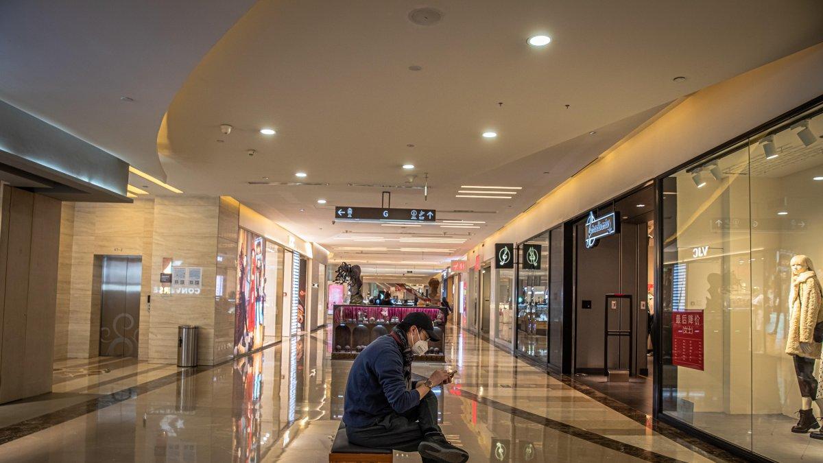 PEKÍN. Un hombre descansa en medio de un pasillo de uno de los centros comerciales más concurridos en esta capital, donde sus habitantes siguen en sus casas por temor al contagio de coronavirus.