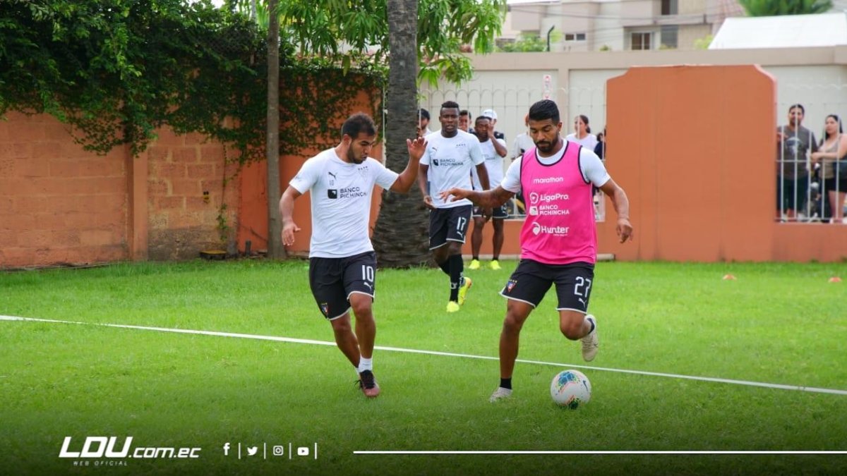 Junior Sornoza (i) y Rodrígo Aguirre, de Liga, antes de la suspensión de los entrenamientos.