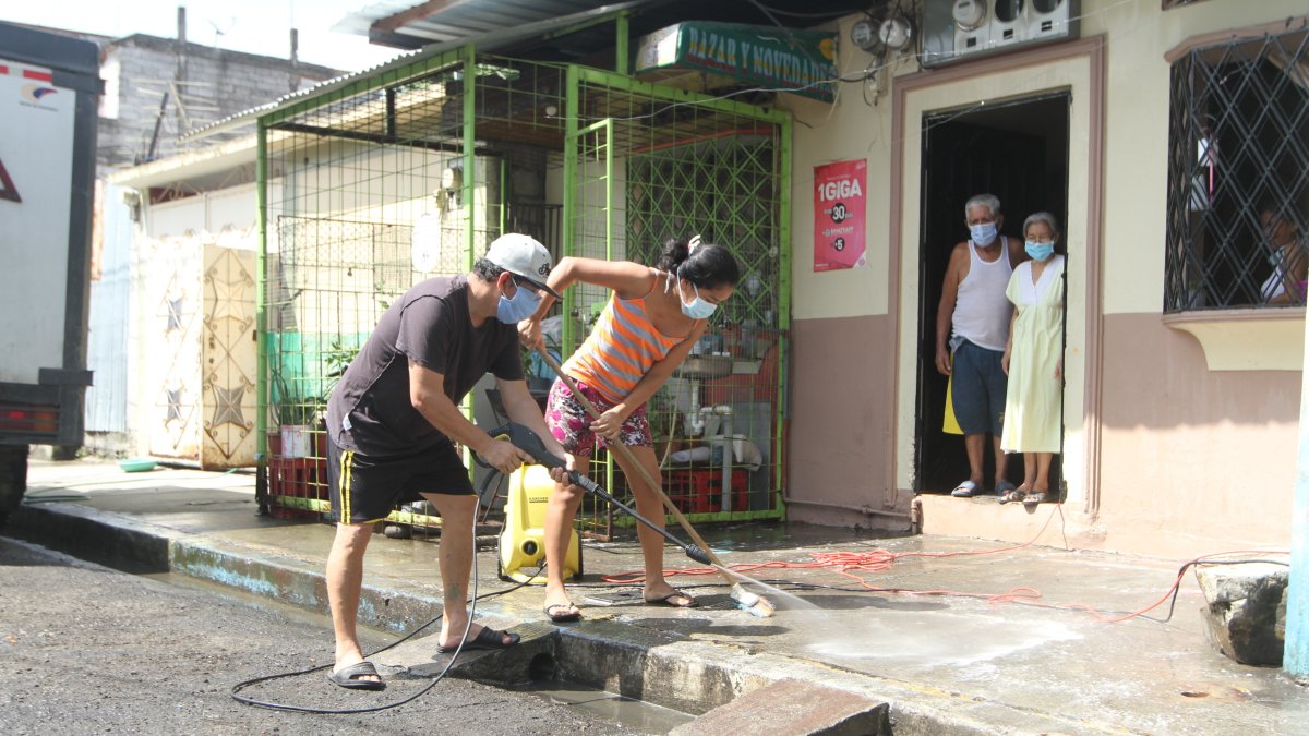 Ciudadanos de la 12 y la B en Guayaquil realizan la limpieza de sus cuadras como medida de prevención del virus.