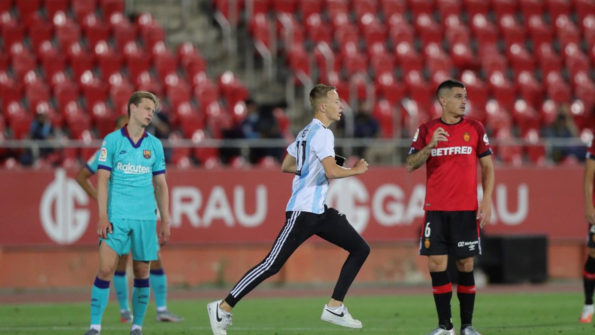 Un aficionado se trepó el muro del estadio y después se metió a la cancha buscando una foto con Lionel Messi.
