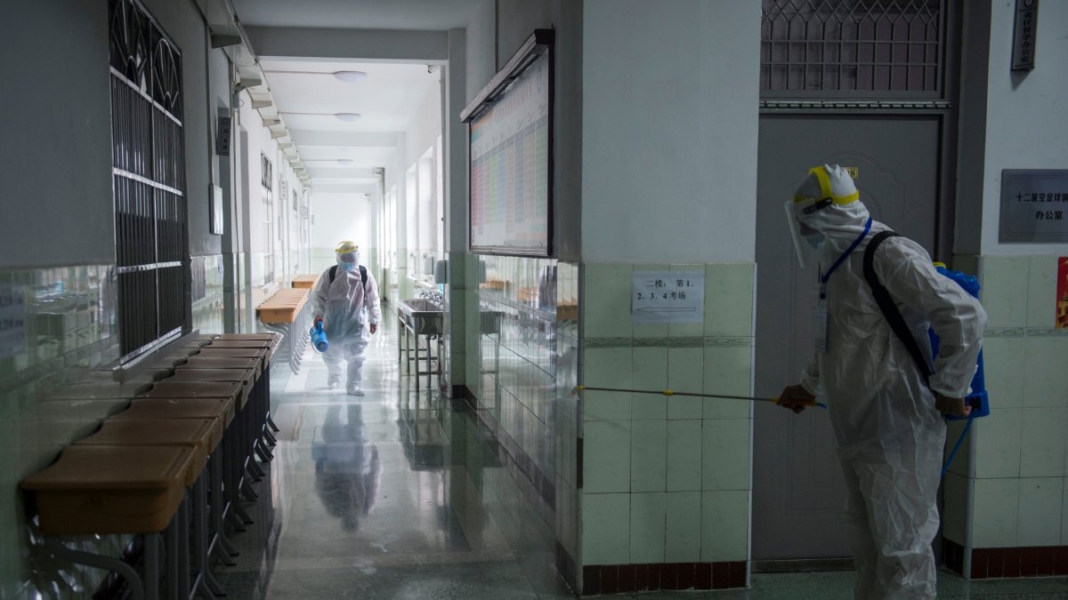 WUHAN. Personal sanitarios desinfectan un área de una escuela antes del Examen de ingreso a la universidad nacional (NCEE), conocido como Gaokao.