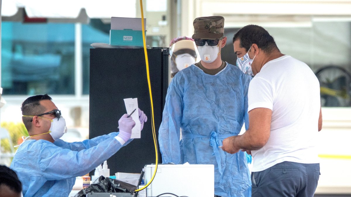 Personas acuden a un centro de pruebas rápidas de COVID-19 en Miami Beach, este 23 de julio.