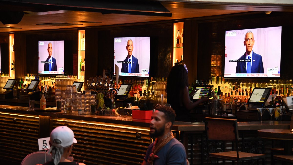 Barack Obama, es visto en las pantallas de televisión mientras habla durante el tercer día de la Convención Nacional Demócrata, en el bar y restaurante The Abbey en West Hollywood, California