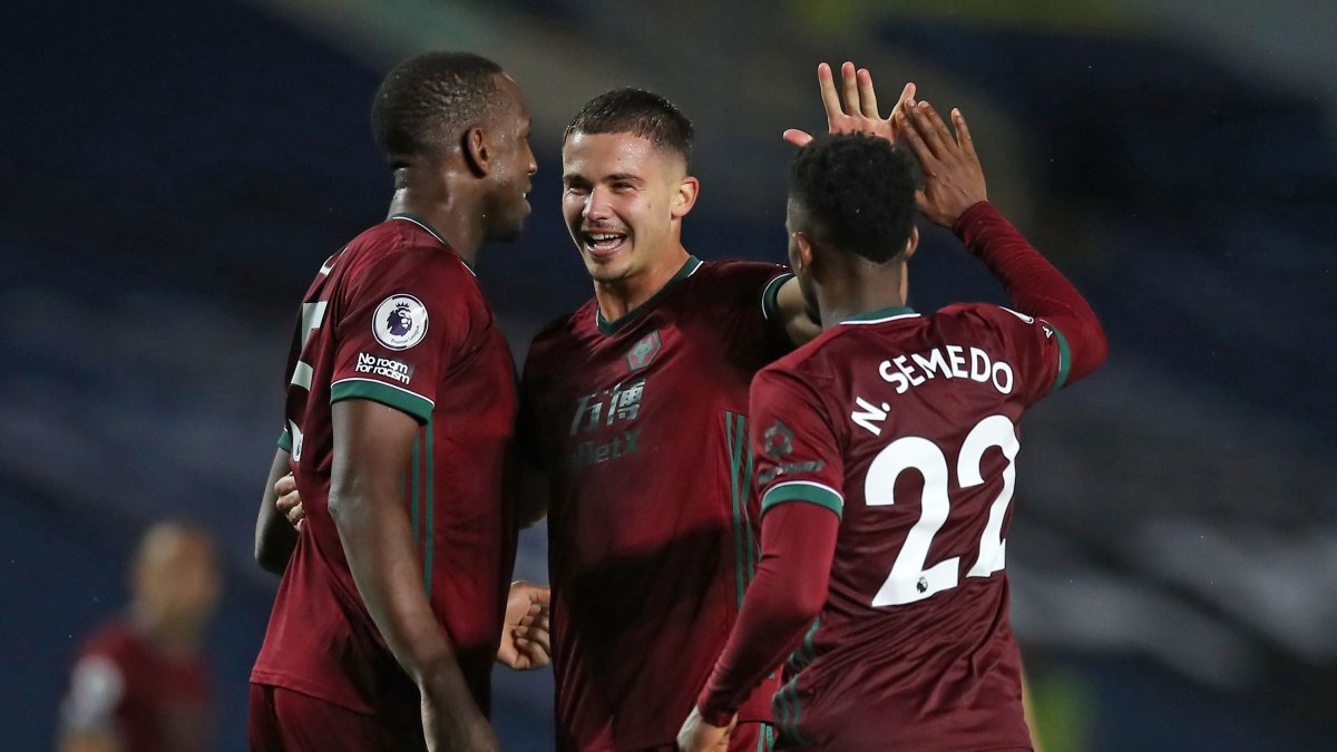 Leander Dendoncker (C) celebra con Willy Boly (I)  Nelson Semedo (D) tras consumarse la victoria sobre el Leeds