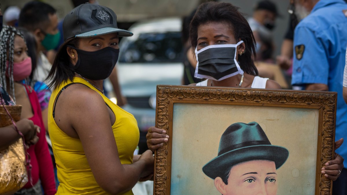 Decenas de personas asisten a una ceremonia de exhumación de los restos de José Gregorio Hernández hoy, en las inmediaciones de la iglesia de Nuestra Señora de La Candelaria, en Caracas.