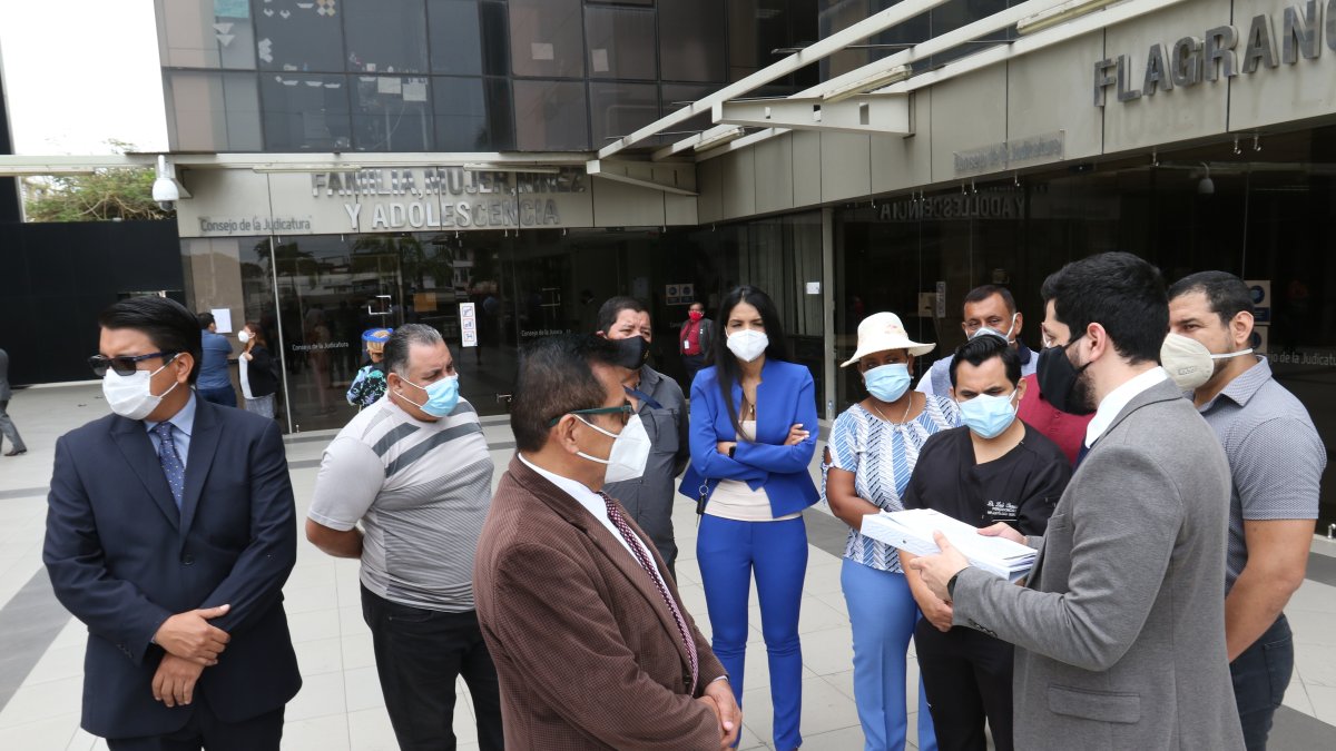 Los aspirantes del concurso escuchan al abogado que los representa.