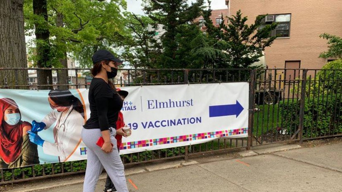 La cuencana Jackeline Peralta y su hijo acuden al Hospital Elmhurst, de Nueva York, para vacunarse, este viernes 28 de mayo,