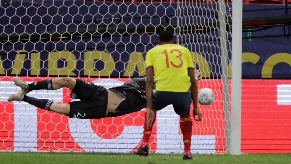 Yerry Mina de Colombia patea un penalti hoy ante Emiliano Martínez de Argentina, durante un partido por las semifinales de la Copa América.
