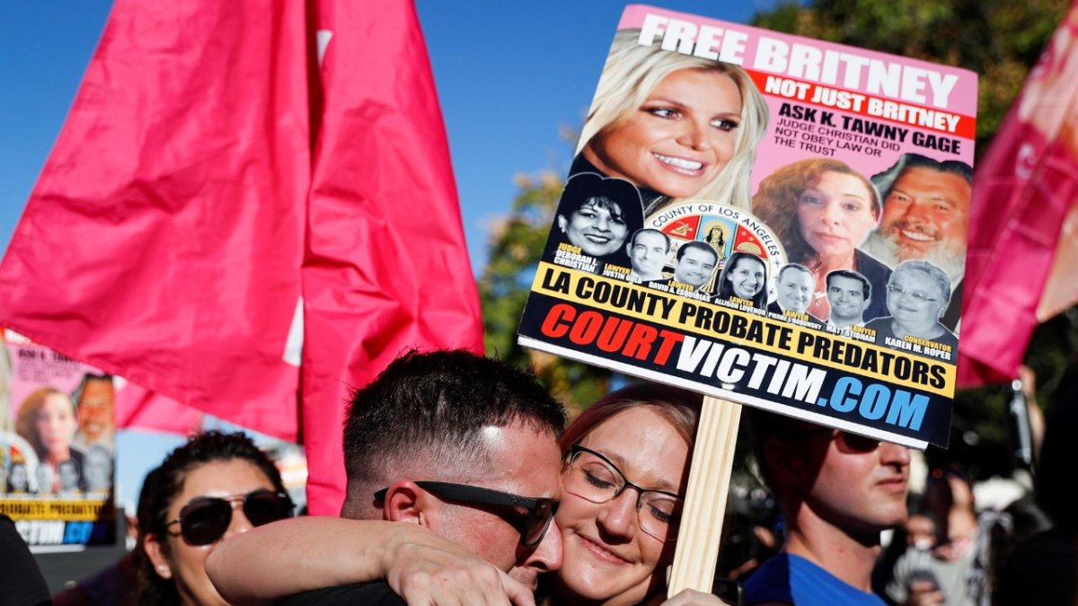 Aaron Morris (L) and Elizabeth Crocker (R) embrace upon hearing the news that Britney Spears'Äô conservatorship has been terminated, at the Stanley Mosk Courthouse in Los Angeles, California, USA, 12 November 2021.