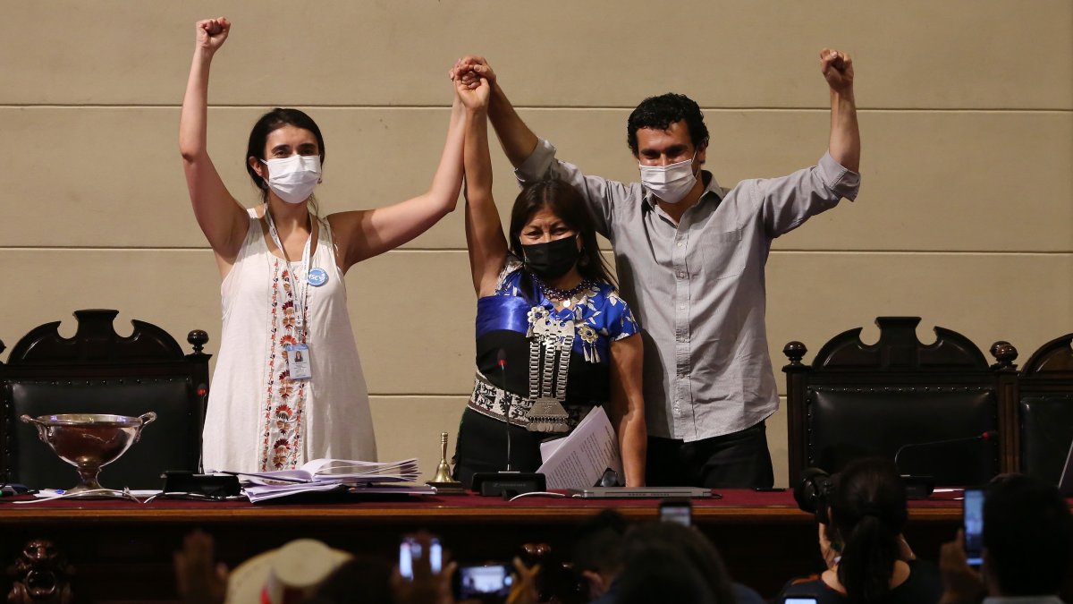 La saliente presidenta de la Convención Constitucional de Chile, Elisa Loncon (c), y el vicepresidente Jaime Bassa (d), saludan hoy a la nueva presidenta del ente, María Elisa Quinteros, EFE/