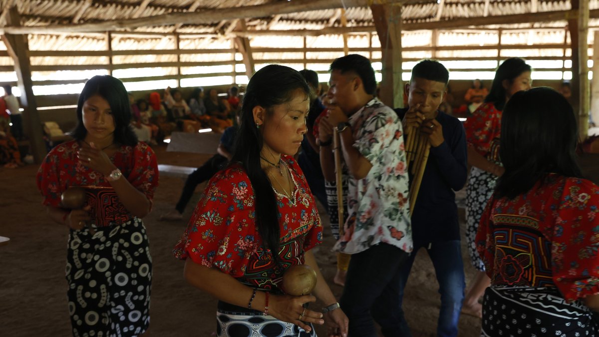 Jóvenes de la comunidad Tule bailan dentro de su resguardo, el 4 de mayo de 2022, en Arquía (Colombia). EFE
