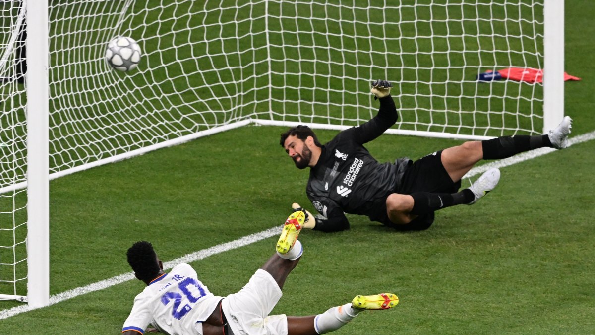 Vinicius Junior (L) of Real Madrid scores the opening goal during the UEFA Champions League final between Liverpool FC and Real Madrid at Stade de France in Saint-Denis, near Paris, France, 28 May 2022.