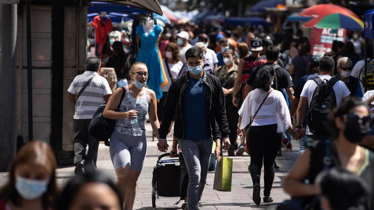 Un hombre carga una bolsa de comercio por una calle del centro de Santiago (Chile)
