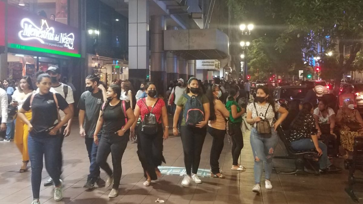 Ciudadanos caminan con mascarillas y otros sin ellas por la avenida 9 de Octubre, en Guayaquil.