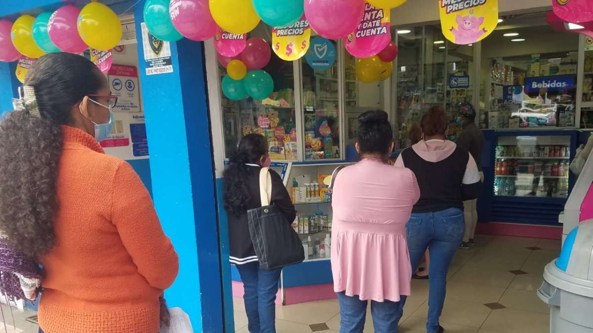 Usuarios esperan su turno en una farmacia adherida al sistema de externalización de medicamentos.