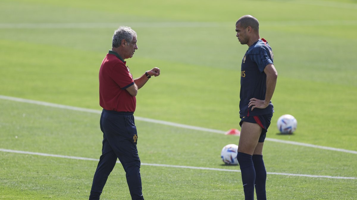 Fernando Santos, técnico de Portugal (i), platica junto al defensor Pepe (d) durante el entrenamiento en Al Shahhniya, Qatar.
