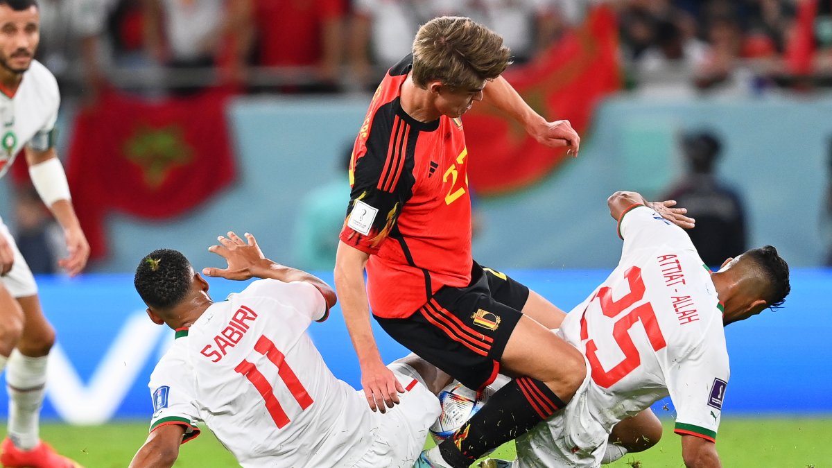 Timothy Castagne (C) de Bélgica en acción contra los jugadores marroquíes Abdelhamid Sabiri (I) y Yahia Attiyat Allah (D